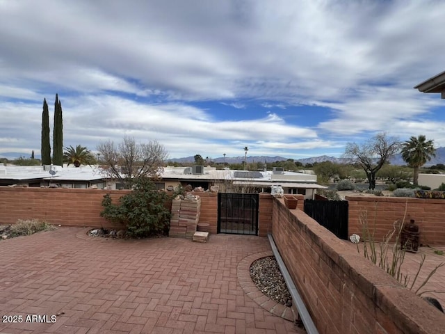 view of patio with a mountain view and fence private yard