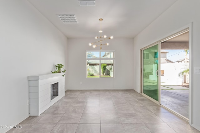 interior space featuring light tile floors and a notable chandelier