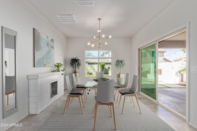 dining space featuring a chandelier and light tile floors