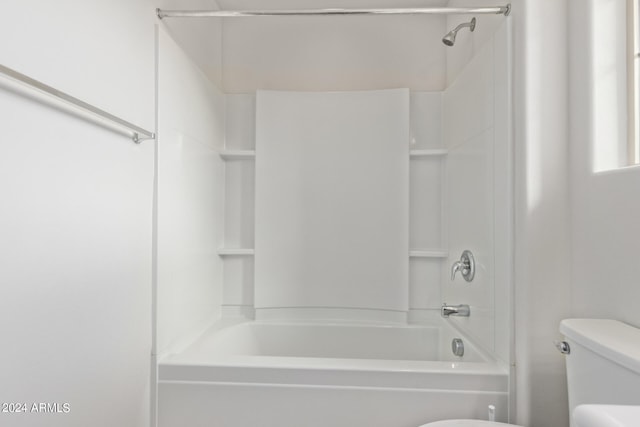 bathroom featuring shower / bathing tub combination and toilet