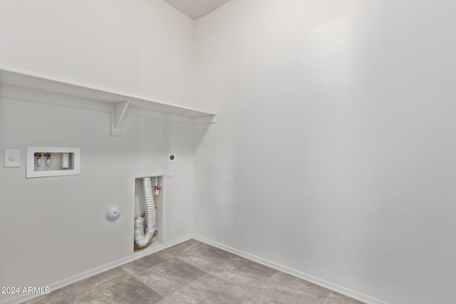 laundry area featuring light tile floors, electric dryer hookup, hookup for a gas dryer, and hookup for a washing machine