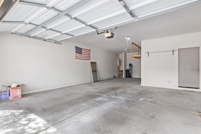 garage with a garage door opener and water heater