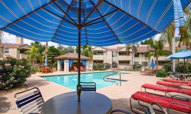 community pool featuring a gazebo, fence, and a patio