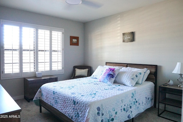 carpeted bedroom featuring multiple windows and a ceiling fan