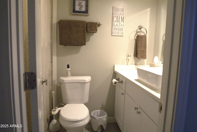 bathroom featuring vanity and toilet