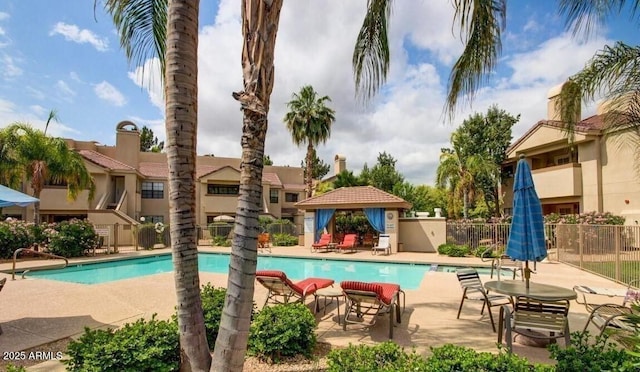 community pool featuring a gazebo, fence, and a patio
