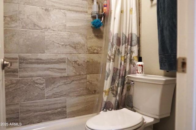 bathroom featuring toilet and a shower with shower curtain