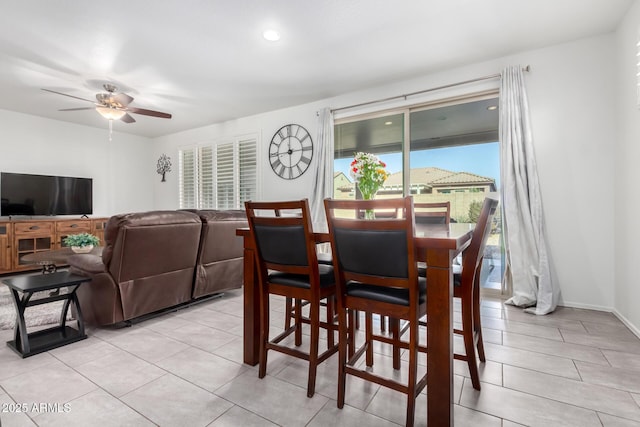 tiled dining room with ceiling fan