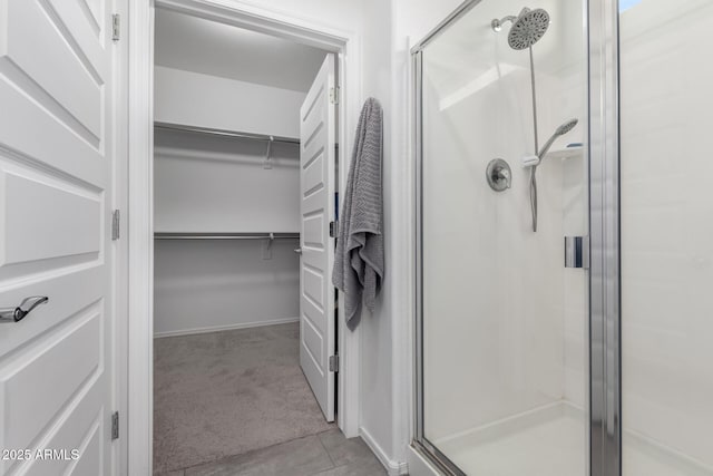 bathroom featuring tile patterned floors and a shower with shower door