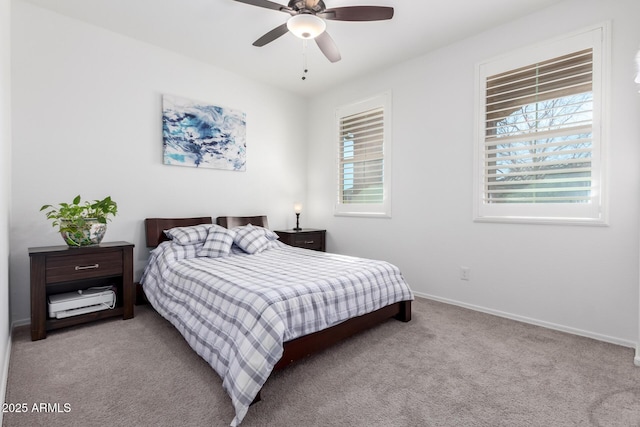 carpeted bedroom with ceiling fan and multiple windows