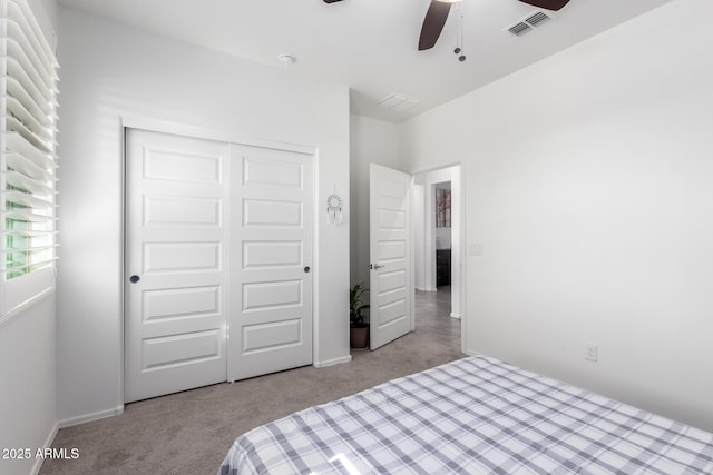 bedroom with light carpet, a closet, and ceiling fan