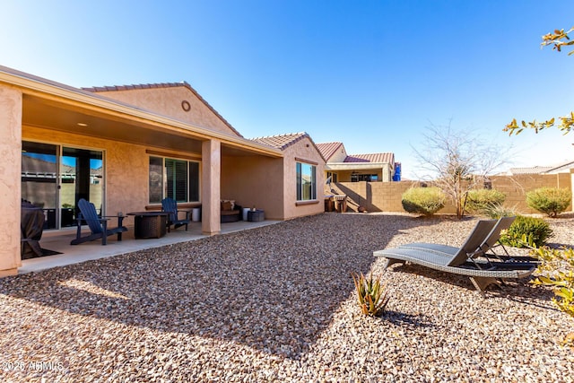 rear view of house featuring a patio