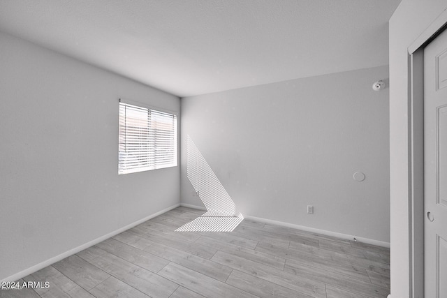 spare room featuring light wood-type flooring