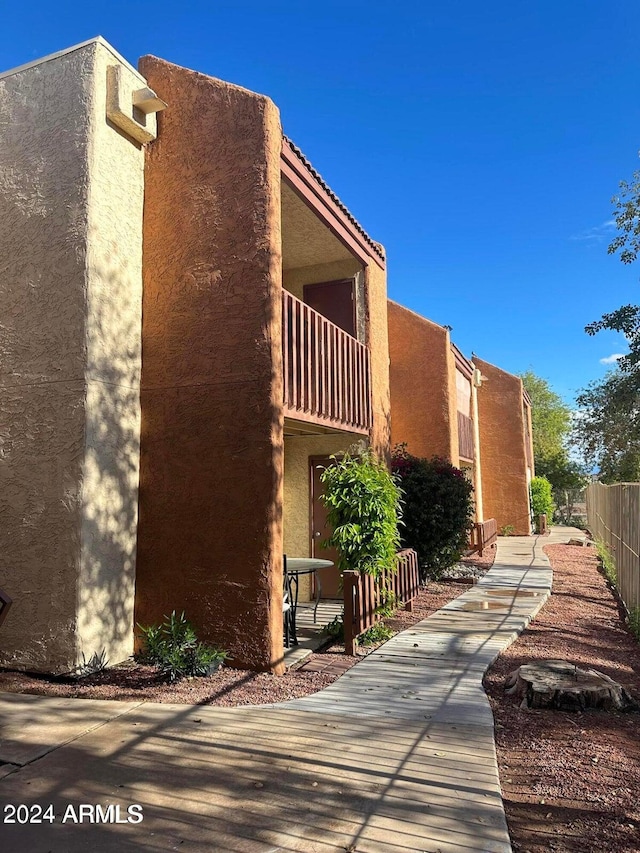 view of side of property with a balcony