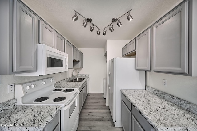 kitchen featuring white appliances, light hardwood / wood-style floors, and gray cabinetry