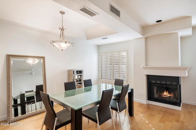 dining room with ceiling fan and hardwood / wood-style flooring