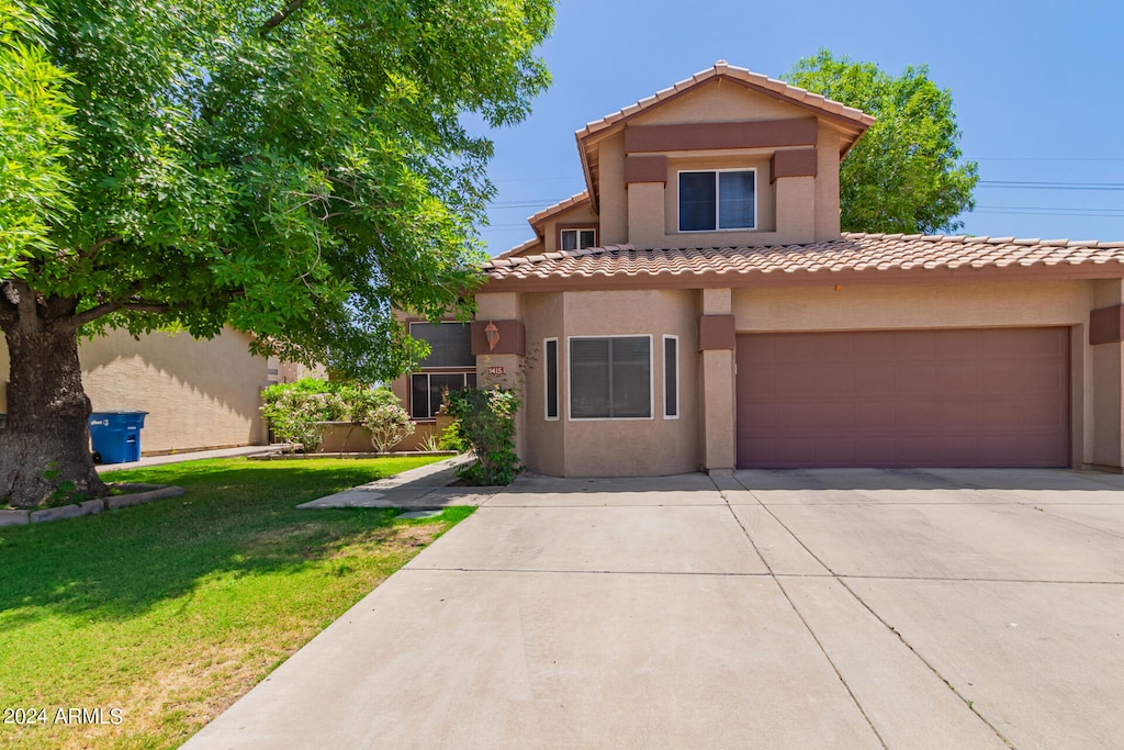 view of front of home with a garage and a front yard