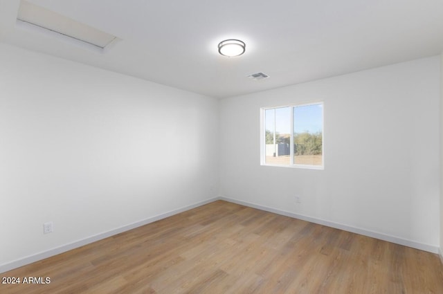 empty room with light hardwood / wood-style flooring