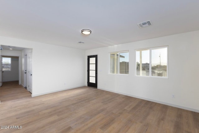 unfurnished room featuring light hardwood / wood-style floors