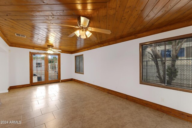 unfurnished room with ceiling fan, light tile patterned flooring, wood ceiling, and french doors