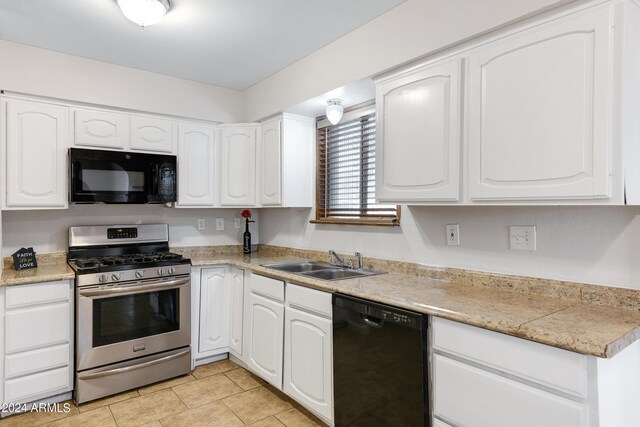 kitchen featuring black appliances, white cabinetry, light tile patterned flooring, and sink