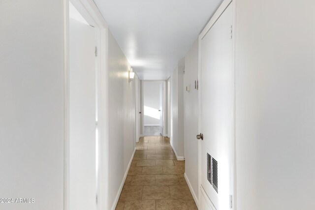 hall with light tile patterned floors