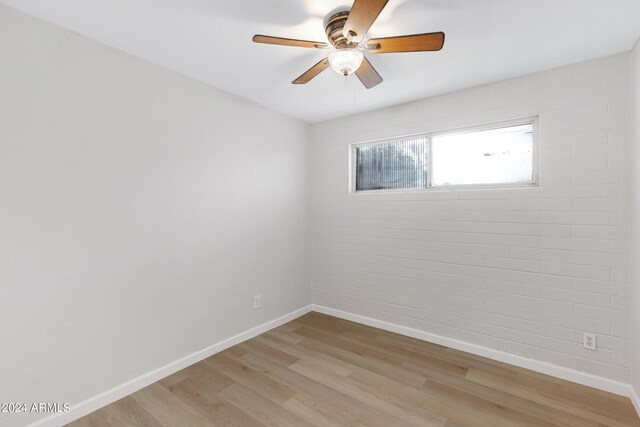 empty room featuring light hardwood / wood-style flooring and ceiling fan