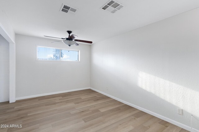 spare room featuring ceiling fan and light hardwood / wood-style flooring