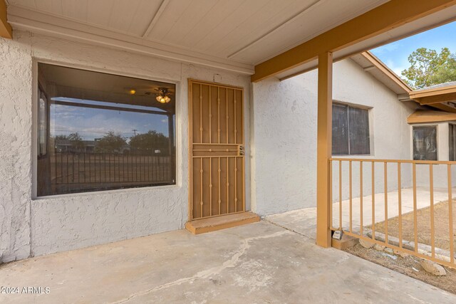 view of exterior entry featuring a patio area