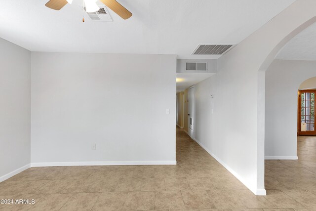 empty room with light tile patterned floors and ceiling fan