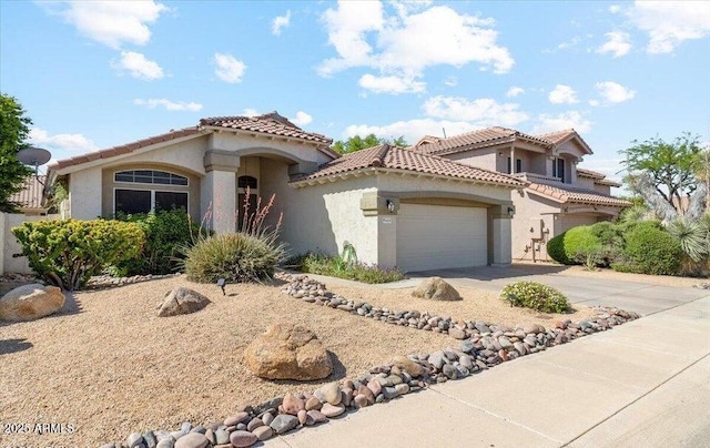 4223 E Wildcat Dr, Cave Creek, AZ 85331 - mediterranean / spanish home featuring stucco siding, an attached garage, concrete driveway, and a tile roof