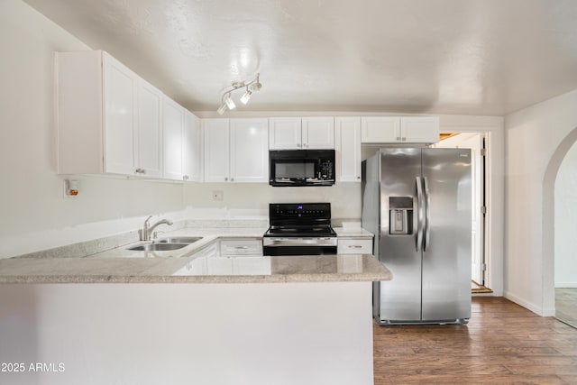 kitchen with stainless steel fridge, a sink, range with electric cooktop, dark wood finished floors, and black microwave