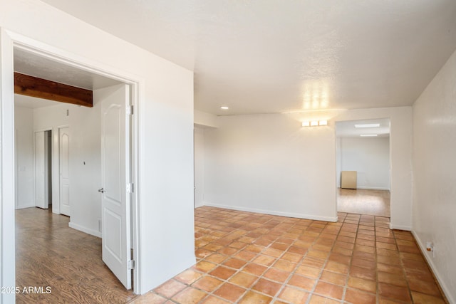 empty room featuring baseboards and recessed lighting