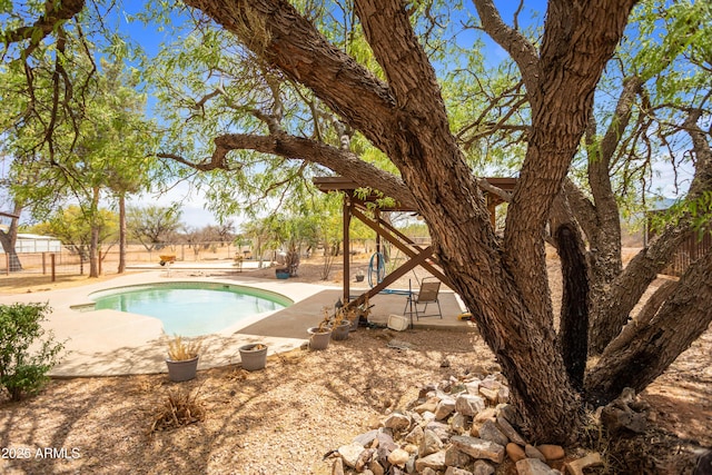pool with a patio and a fenced backyard