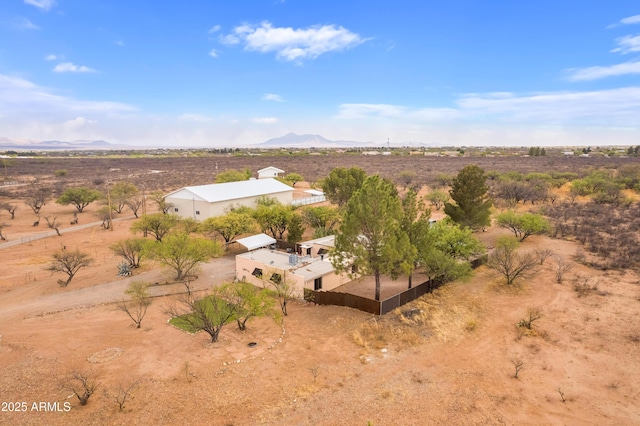 aerial view featuring a rural view, a desert view, and a mountain view