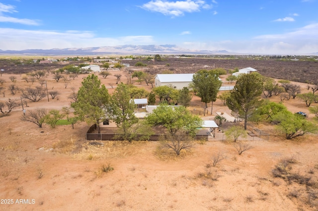 birds eye view of property featuring a mountain view, a rural view, and view of desert