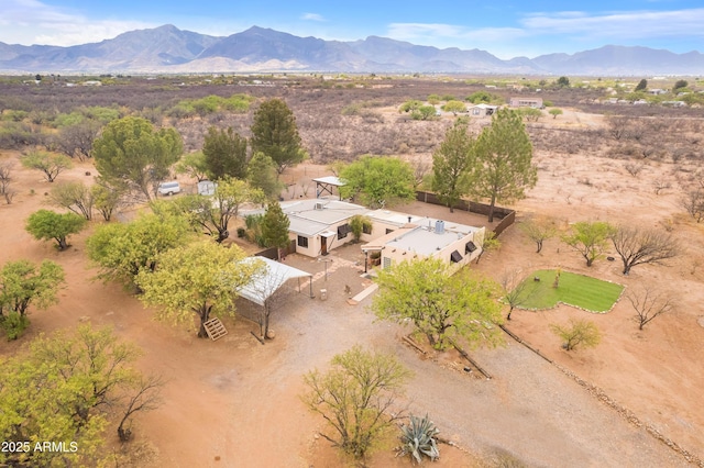drone / aerial view with a rural view, view of desert, and a mountain view