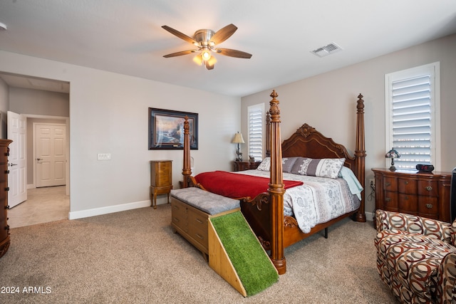 bedroom with ceiling fan and light carpet