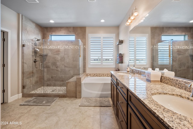 bathroom with plenty of natural light, tile floors, plus walk in shower, and dual vanity