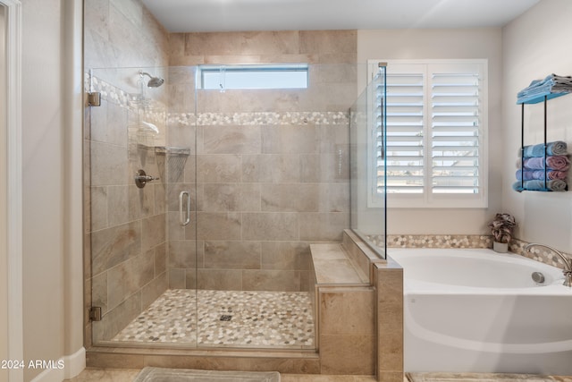 bathroom with separate shower and tub