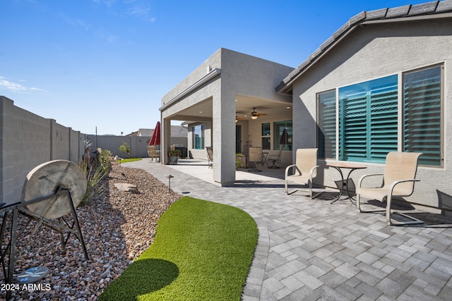 exterior space featuring ceiling fan