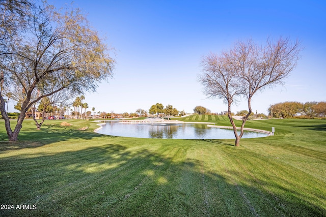 view of home's community featuring a water view and a yard