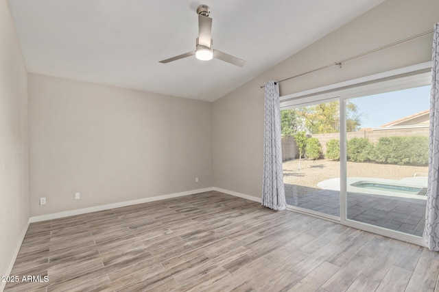 empty room with vaulted ceiling, baseboards, light wood finished floors, and ceiling fan