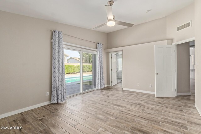 unfurnished room featuring visible vents, baseboards, ceiling fan, and light wood finished floors