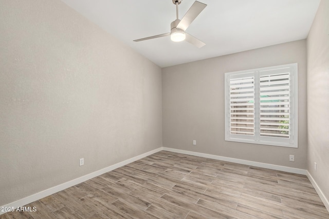 unfurnished room with baseboards, light wood finished floors, and ceiling fan