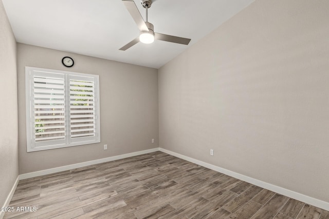 spare room with ceiling fan, baseboards, and wood finished floors