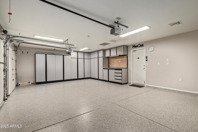 garage with visible vents and a garage door opener