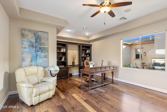 office area featuring baseboards, visible vents, wood finished floors, and a ceiling fan
