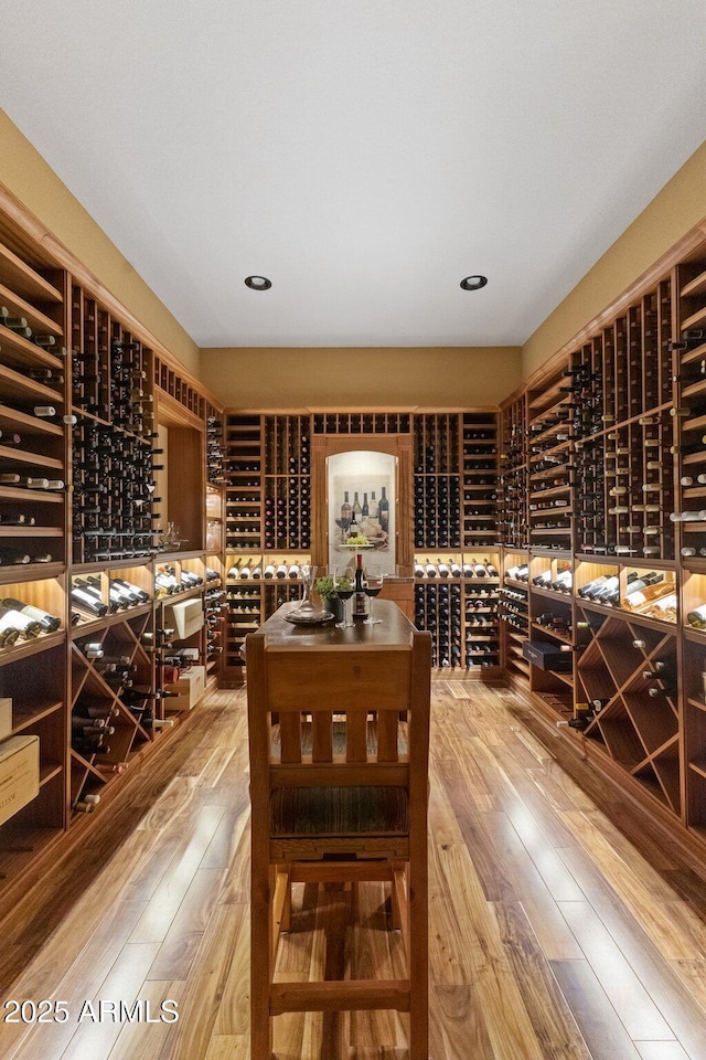 wine area with hardwood / wood-style floors and recessed lighting