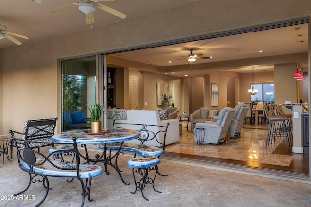 view of patio featuring an outdoor hangout area, a ceiling fan, and outdoor dining area